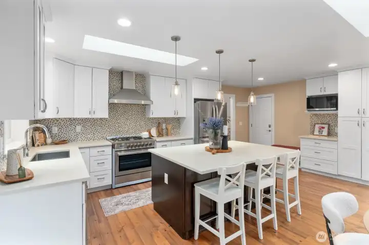 Gourmet kitchen with quartz counters, stainless appliances, and a large center island.