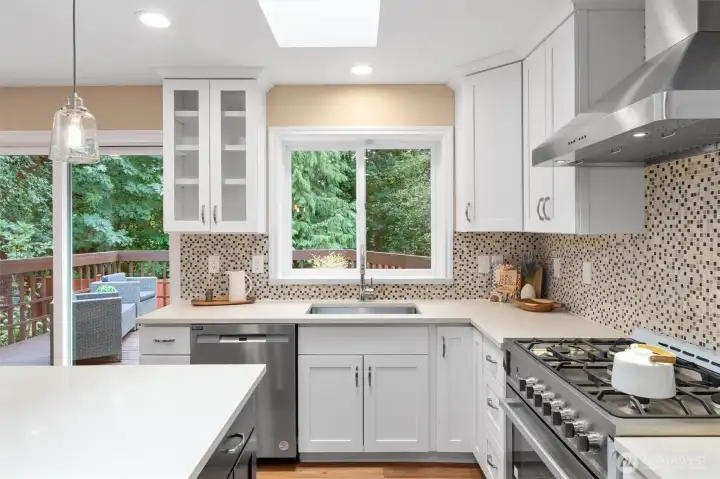 Gourmet kitchen with quartz counters, stainless appliances, and a large center island.