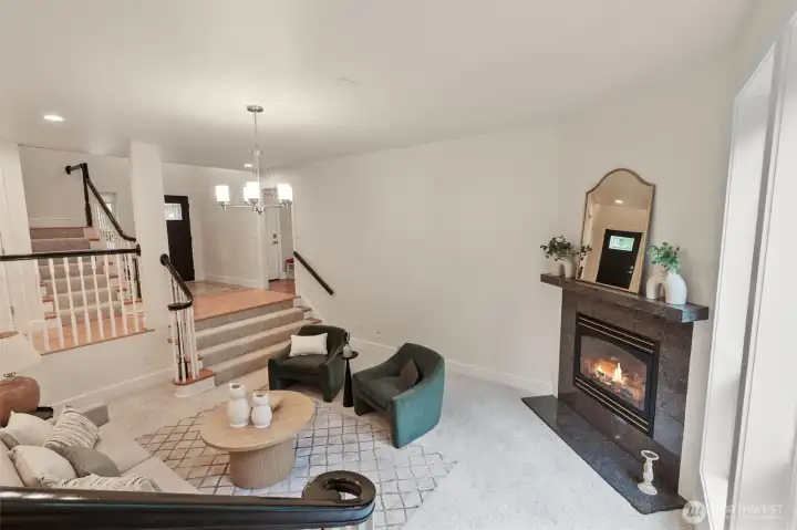 Light-filled living room with large windows and warm hardwood flooring