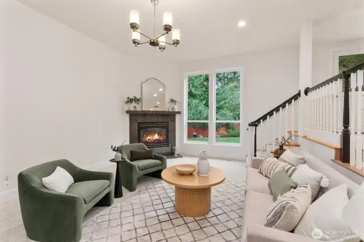 Light-filled living room with large windows and warm hardwood flooring