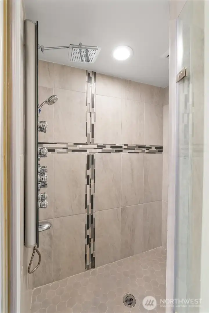 Luxurious, updated primary bath with modern finishes and generous storage.