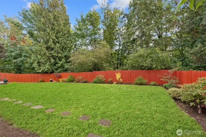 Side yard with easy access around the home and additional outdoor space.