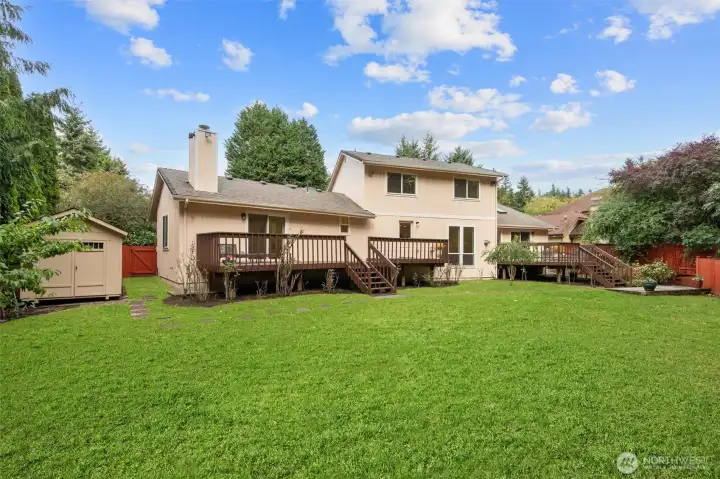 Large, fully fenced, level backyard backing to a greenbelt for privacy and play.