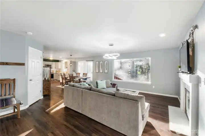 The great room is spacious and features a picture window overlooking the lake and giving the feeling that you live in a tranquil treehouse