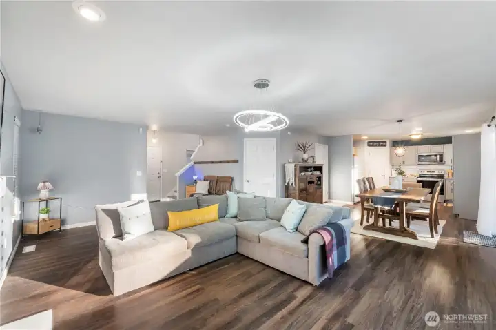 The open concept great room is generous and shows off all the laminate hardwood flooring througout