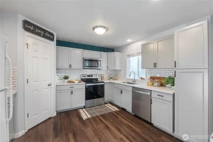 The updated kitchen is the perfect spot for whipping up marvelous meals. The walk-in pantry can store the goods from your Costco run and the subway tile backsplash is lovely