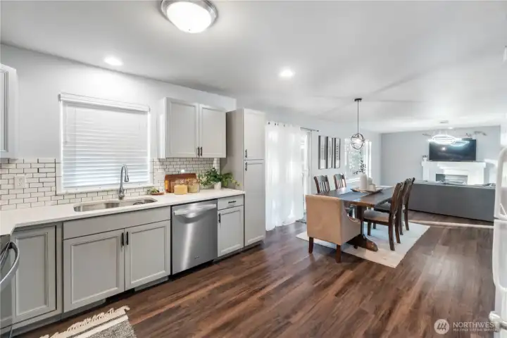 The kitchen features upgraded, soft-close cabinets & drawers with decorative pulls and an inlaid stainless sink & faucet