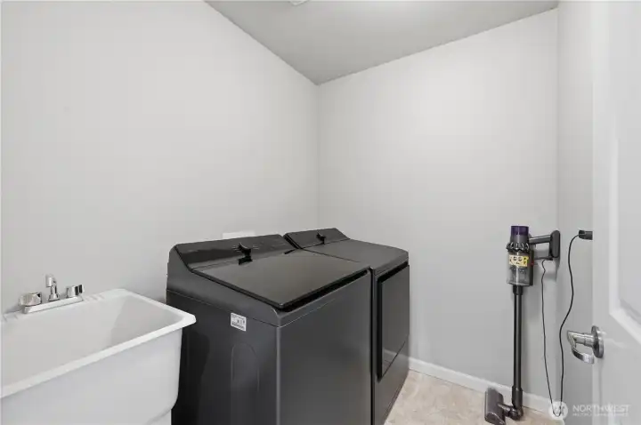 Wonderful laundry room with new washer/dryer & sink.  Add some cabinets or shelves to maximize storage.