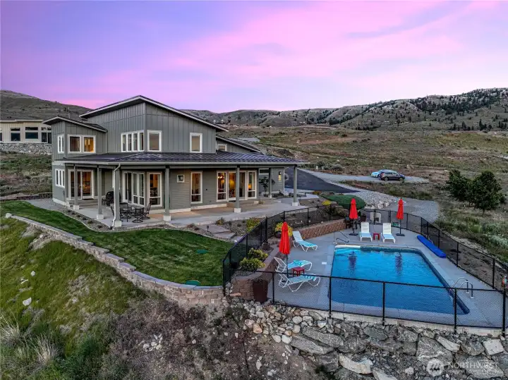 Aerial twilight view of home and pool.
