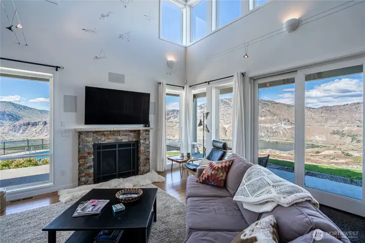 View 1 of Living Room with fireplace and oversized windows overlooking the Columbia River.