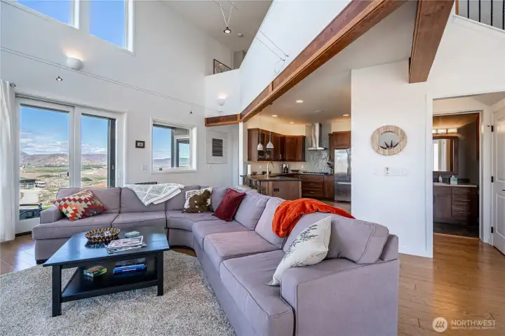 View 3 of Living Room with exposed beams and oversized windows overlooking the Columbia River.
