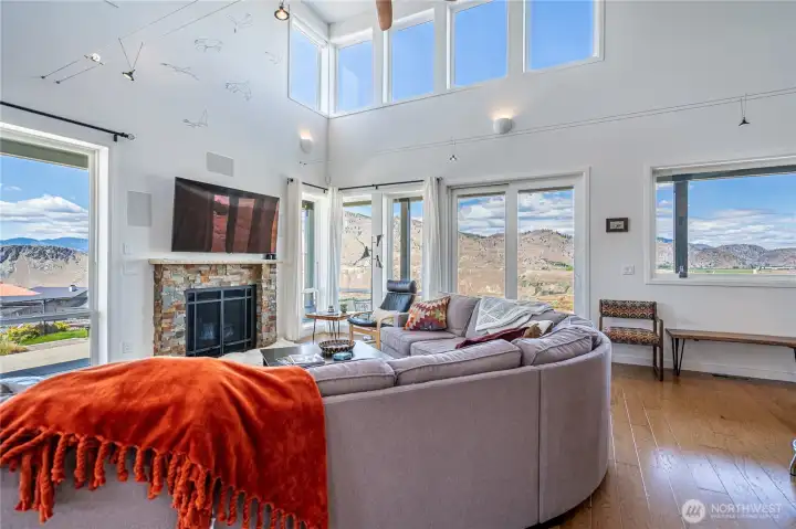 View 4 of Living Room with fireplace and oversized windows overlooking the Columbia River.