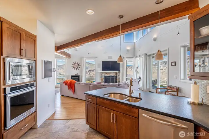 View 1 of kitchen with wood cabinets, high-end stainless steel appliances and granite countertops.