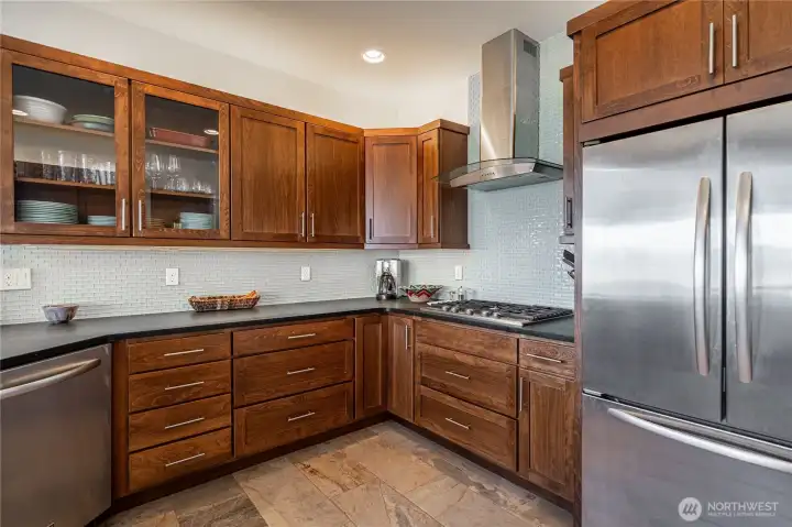 View 2 of kitchen with wood cabinets, high-end stainless steel appliances and granite countertops.