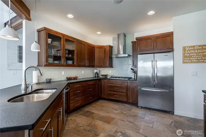 View 4 of kitchen with wood cabinets, high-end stainless steel appliances and granite countertops.