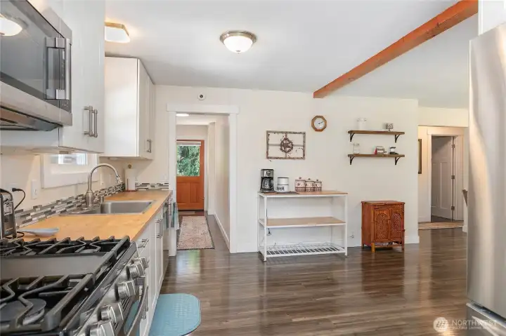 From the kitchen you can utilize the back entry, primary bedroom or the daylight basement/ADU.