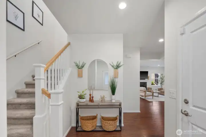 Entry leads you to a grand opening and access upstairs