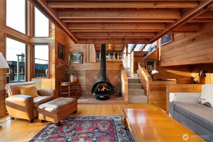 The living room is incredibly inviting.  Viewpoint facing north in this photo.  The carpeted stairs lead to the next level; dining room.