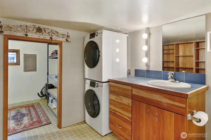 A combination half bath, utility room, and extra storage room.  In addition, there is a hatch that opens up to more storage, like a crawl space inside the home.