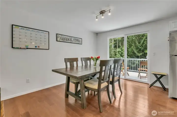 Natural light pours into the dining room through expansive windows, making every meal feel warm, bright, and inviting.