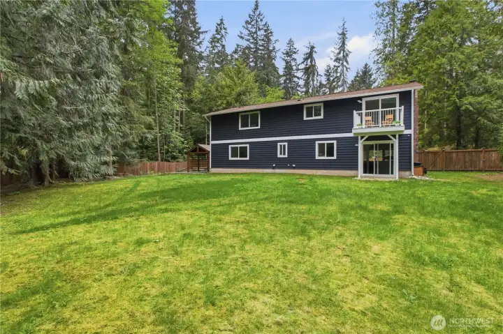 The fully fenced backyard is level, usable, and designed for entertaining with multiple gathering spaces to enjoy year-round.