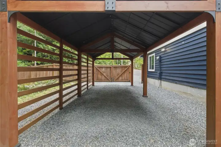 A covered carport adds convenience and flexibility, perfect for extra parking, outdoor storage, or hobby space.