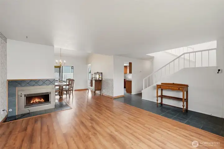 The living room opens to the dining room, back hallway and stairs.