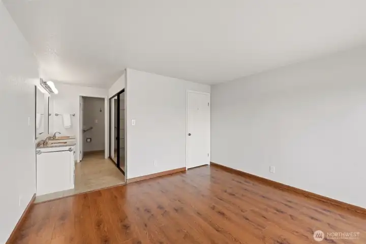 Another view of the primary suite shows the en-suite bathroom.