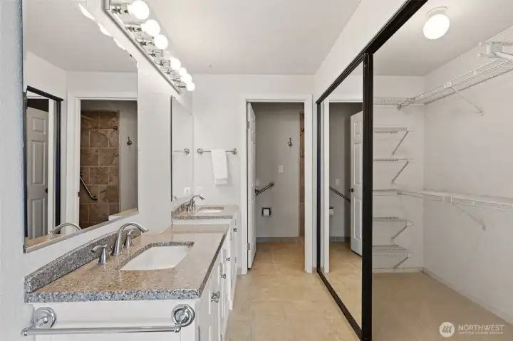 Updated primary bath has dual sinks and privacy room for shower and commode.
