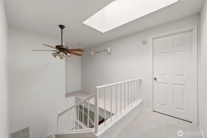 Venture upstairs to find another skylight and a decorative art shelf.