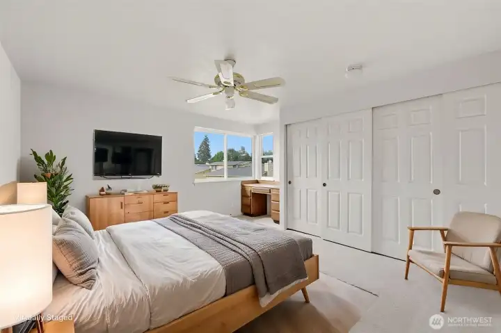 The first upstairs bedroom has dual closets and built in desk. (Shown virtually staged)