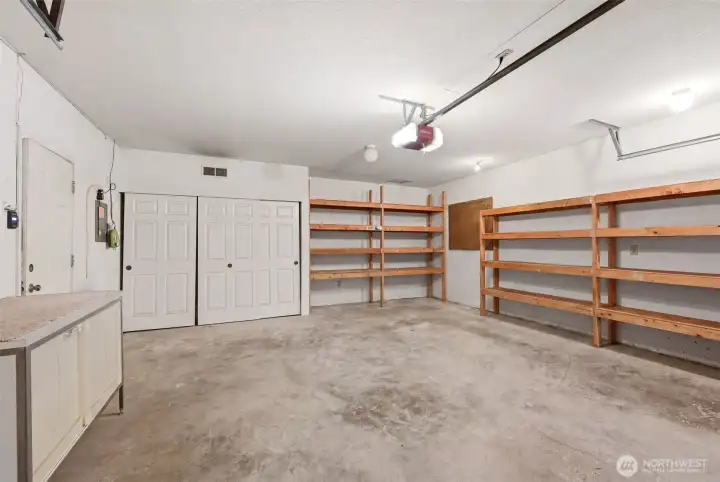 The large two car garage offers storage shelves and closet space.