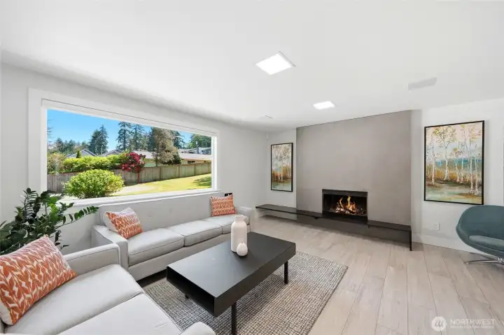 Spacious main living area with abundant natural light and a cozy wood-burning fireplace. Spacious main living area with abundant natural light and a cozy wood-burning fireplace.