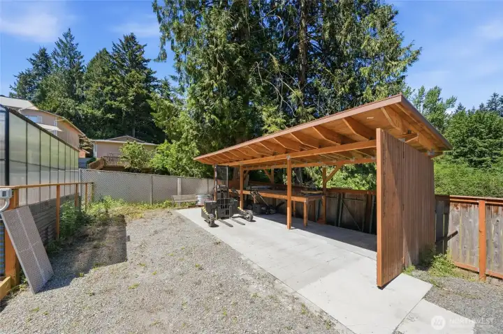 Greenhouse ready for year-round gardening and additional outbuilding offering additional storage or workspace. Greenhouse ready for year-round gardening and additional outbuilding offering additional storage or workspace.