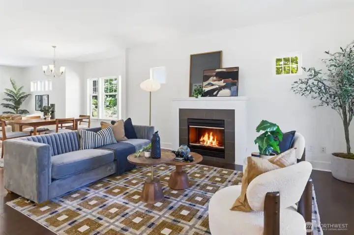 Living room area with fireplace accent. The open main level has high ceilings and abundant natural light. Living room area with fireplace accent. The open main level has high ceilings and abundant natural light.