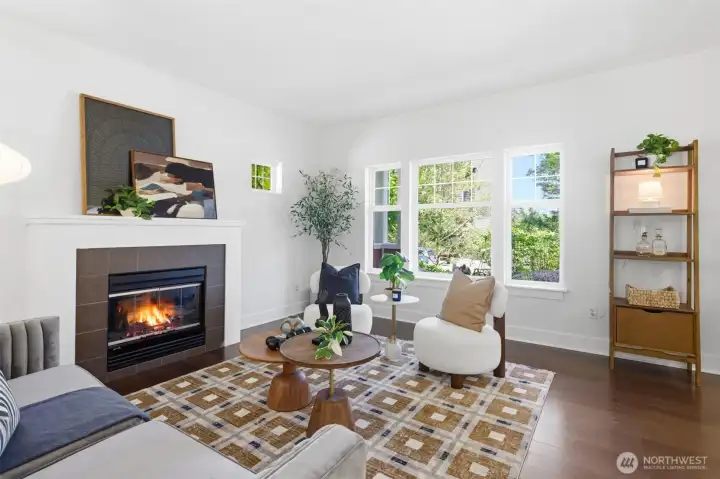 Sunlight pours through generous windows, highlighting red oak floors, high ceilings, and an elegant layout that feels both expansive and serene. Sunlight pours through generous windows, highlighting red oak floors, high ceilings, and an elegant layout that feels both expansive and serene.