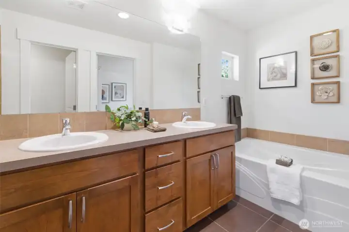 Primary ensuite tiled bath with large soaking tub and separate shower. Primary ensuite tiled bath with large soaking tub and separate shower.