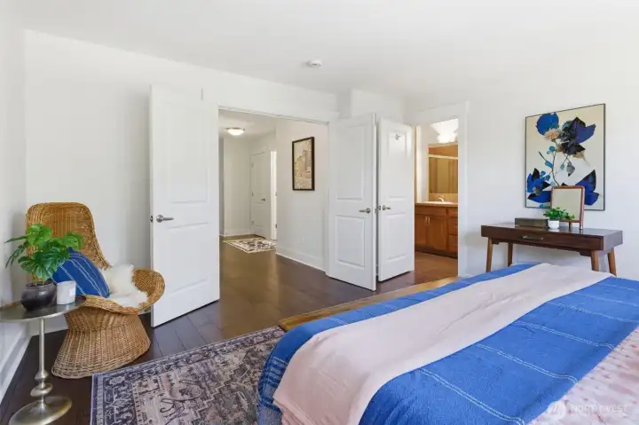 Primary bedroom with French doors, two walk-in closets, and an ensuite bath with dual vanities, a deep soaking tub, and a separate tiled shower. A private getaway. Primary bedroom with French doors, two walk-in closets, and an ensuite bath with dual vanities, a deep soaking tub, and a separate tiled shower. A private getaway.