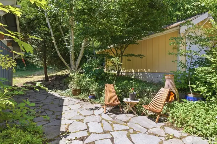 Step outside to a private yard designed for connection and relaxation, complete with a stone patio, mature gardens, and direct access to greenspace—perfect for games, gatherings, or simply unwinding outdoors. Step outside to a private yard designed for connection and relaxation, complete with a stone patio, mature gardens, and direct access to greenspace—perfect for games, gatherings, or simply unwinding outdoors.
