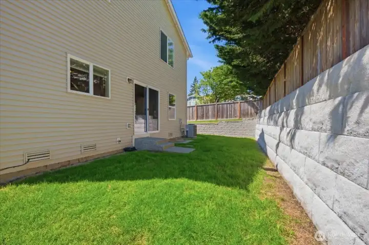 Back yard with small patio area.