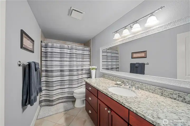 Hall bath between two secondary bedrooms and loads of counter space
