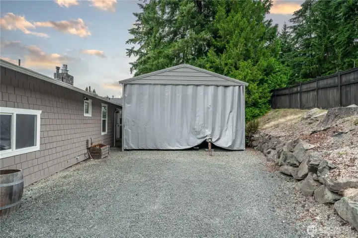 Double carport fully enclosed. Able to fit 4 cars, a large full sized RV or two boats.