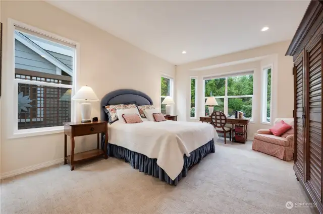 Enjoy the gorgeous greenspace views from the spacious primary bedroom.