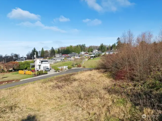 Photo taken from Buck Rd, looking at the land and the culdesac in the background.  Subject property is across the street from the white house with yellow fence