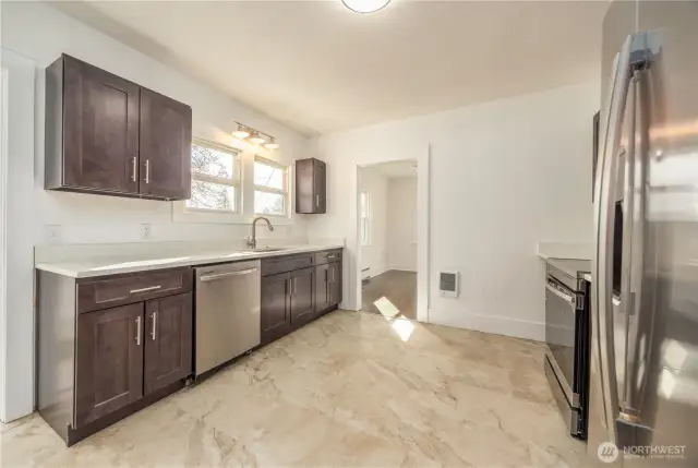 Kitchen has been totally remodeled... new floors, cabinets, dishwasher, stove, sink, microwave ....freshly painted and ready for a homecooked meal.