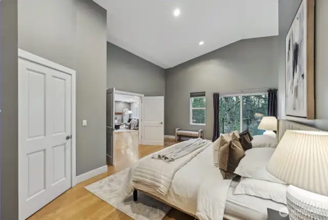 Looking across the primary bedroom, closet on the left, French Doors, with ample private sitting area(s).