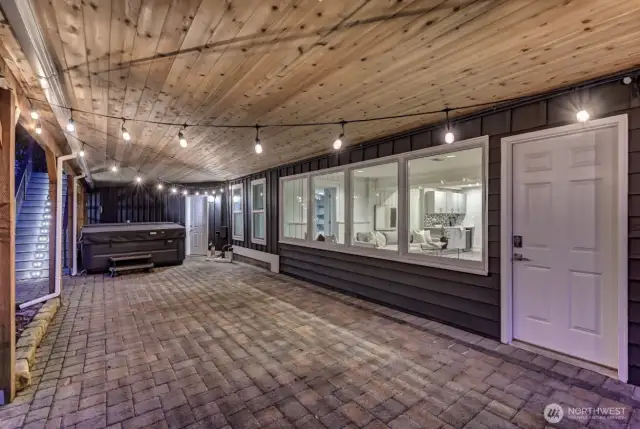 Patio under the deck with direct access to the downstairs family room and outside hot tub.