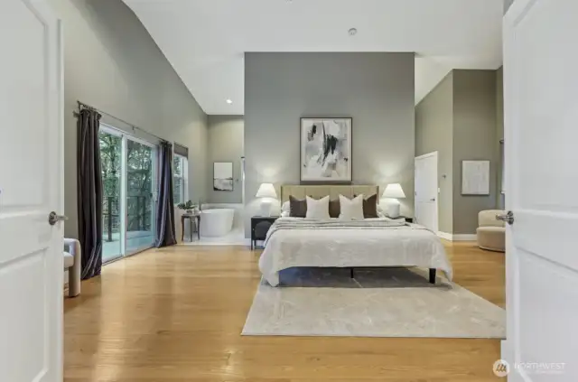 Primary bedroom w vaulted ceilings and open concept area.