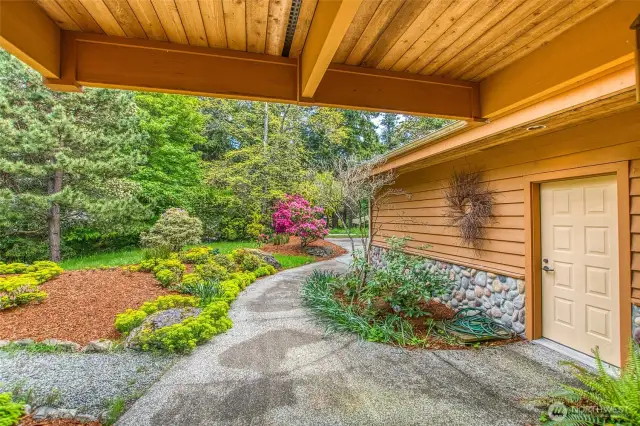 Lovely low maintenance landscaping around the front yard.  Outdoor garage entry near the front door entry.