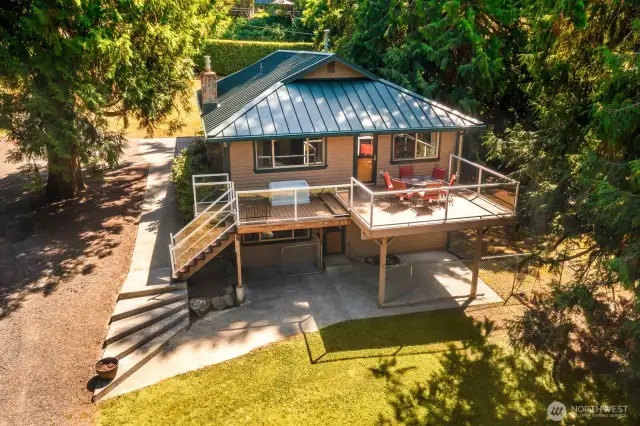 Large back deck perfect for entertaining.  The home offers a large space for your dogs to the side of the home, completely enclosed with a gate